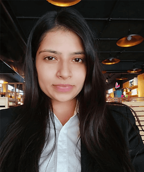 1. Friendly woman in a white shirt and black blazer at a modern cafe for professional cleaning services.